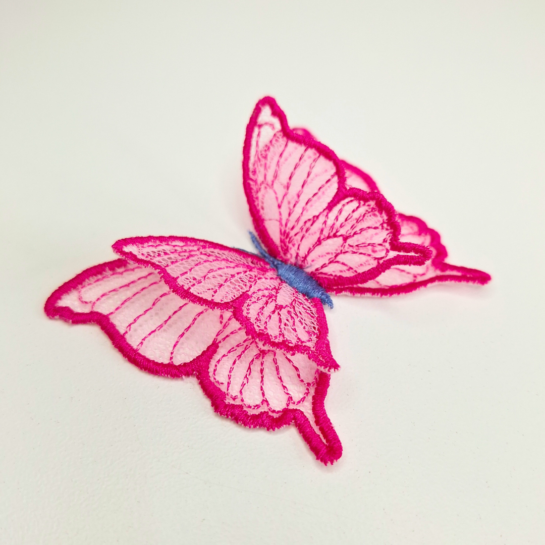 This is an image of a 3D Freestanding Tulle Butterfly. This 3D Tulle Butterfly is a downloadable machine embroidery design from Stitches & Strokes. This butterfly machine embroidery design fits a 4x4 inch machine embroidery hoop. Our 3D butterfly is easy to make and suitable for both beginner and advanced embroiderers. 