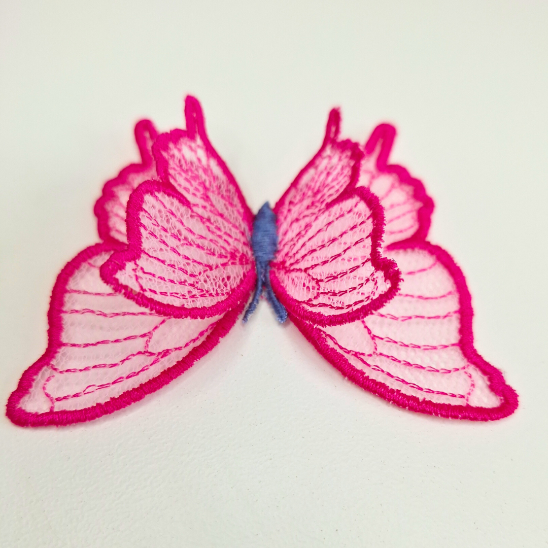 This is an image of a 3D Freestanding Tulle Butterfly. This 3D Tulle Butterfly is a downloadable machine embroidery design from Stitches & Strokes. This butterfly machine embroidery design fits a 4x4 inch machine embroidery hoop. Our 3D butterfly is easy to make and suitable for both beginner and advanced embroiderers.