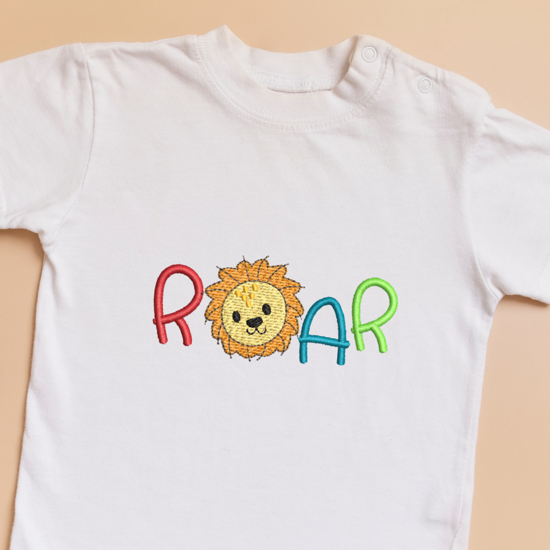 This is a cute simple baby lion with a Roar quote in red, green and blue machine embroidery design for babies and toddler clothes and t-shirts.