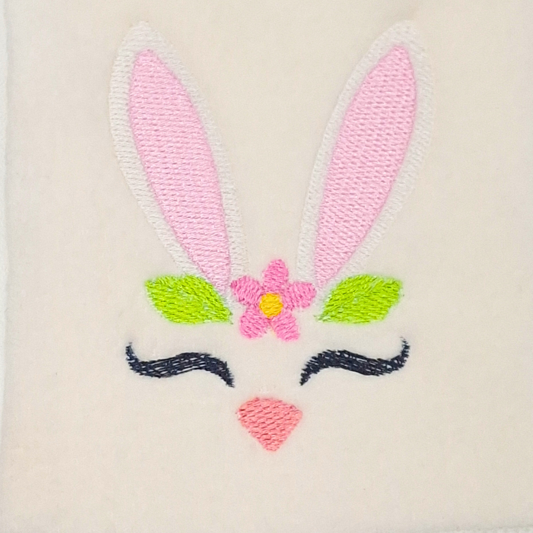 This is an image of a bunny ear silhouette machine embroidery design. The bunny ears with it's cute lashes and bunny nose is perfect for embroidery on girl's t-shirts and accessories, as well as Easter projects.