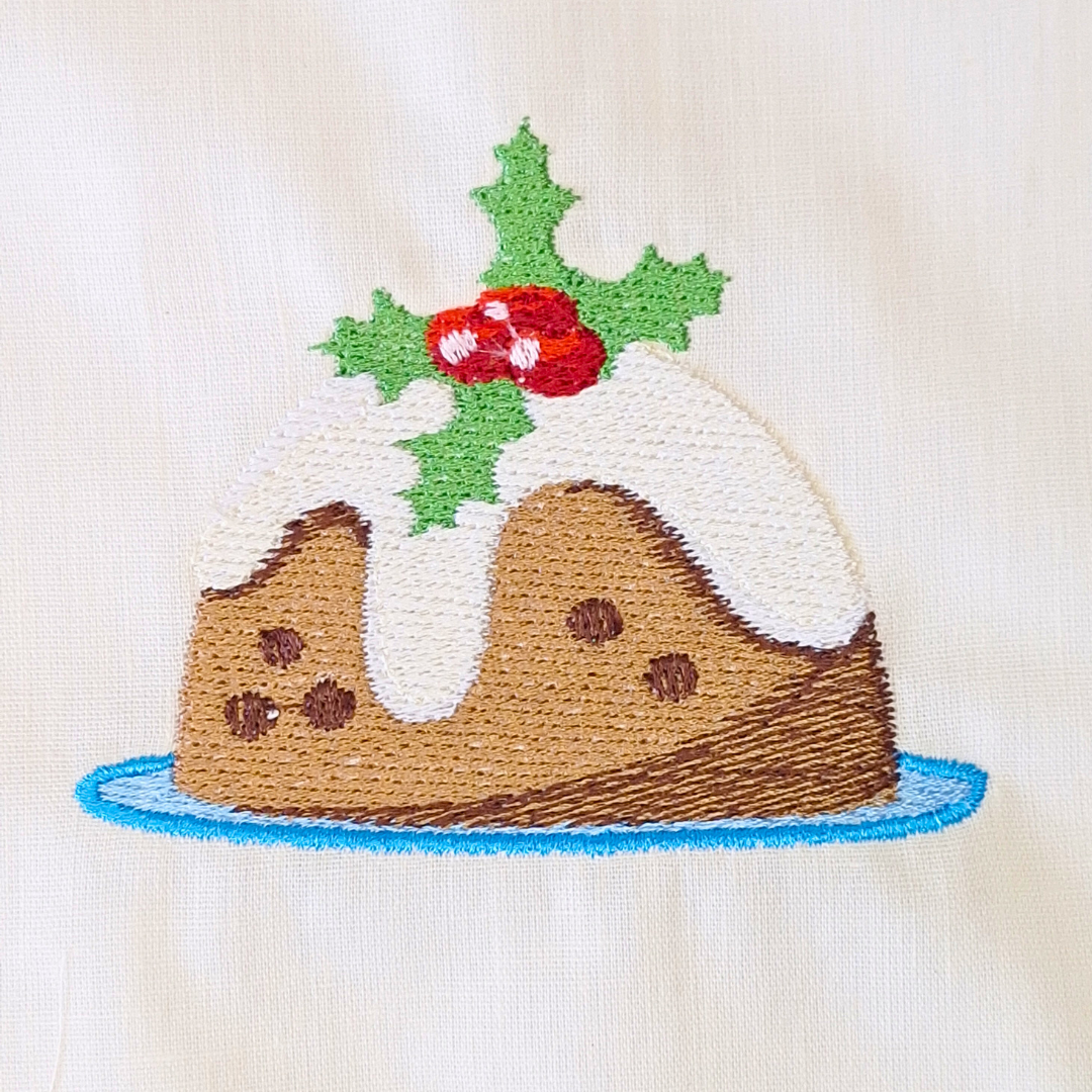 This is an image of a Christmas pudding with frosting and holly spray for decoration machine embroidery design.