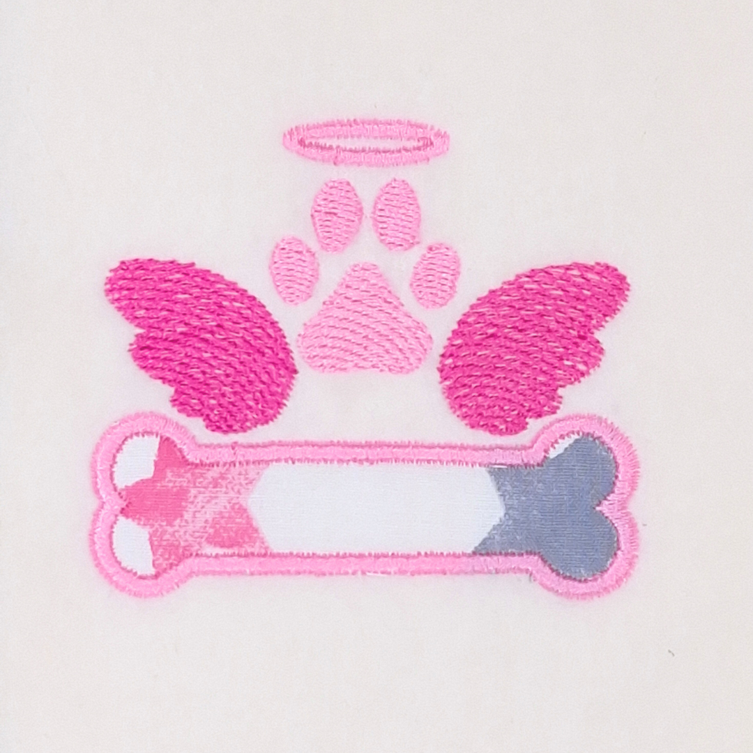 This is an image of an applique machine embroidery design featuring a dog bone and paw with angel wings and halo.