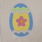 This is an image of an Easter egg in blue and yellow with a pink flower machine embroidery design.