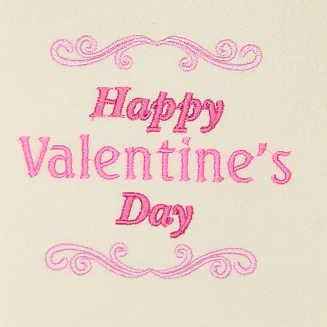 This is an image of a machine embroidery design featuring a "Happy Valentine's Day" Quote with filigree borders.