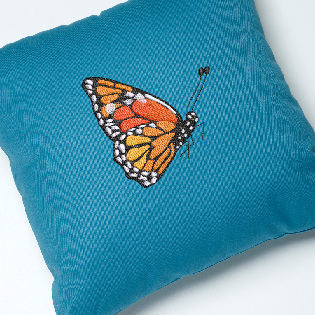 This is an image of a machine embroidery design by Stitches & Strokes, featuring a beautifully detailed Monarch Butterfly. This Monarch Butterfly Machine Embroidery Design is perfect for embroidery on denim, and women and girl's clothing.