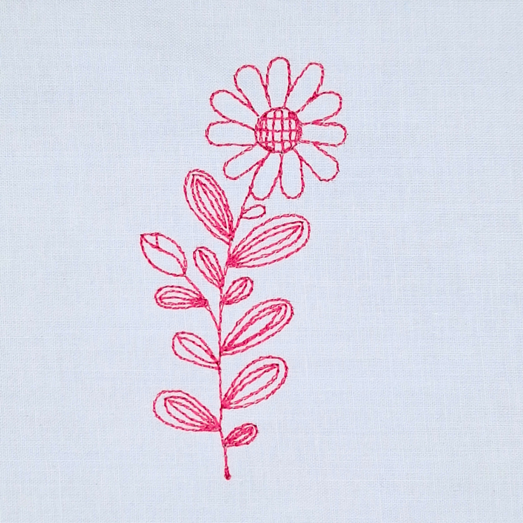 This is an image of a machine embroidery design featuring a single redwork flower. This redwork flower machine embroidery design is perfect for embroidery on blouses, t-shirts, and denim pockets. It will also look beautiful on tablecloths, tea towels, and aprons