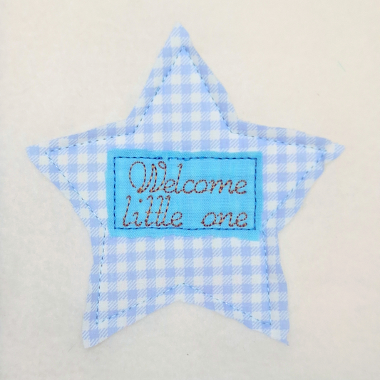 This is an image of an Applique Machine embroidery design featuring a Star with rectangle border and "Welcome little one" Quote. This Applique star machine embroidery star design is perfect for adding detail to baby shower gifts like baby blankets, onesies, burp cloths, and more.