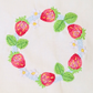 This is an image of a machine embroidery design featuring strawberries with green leaves and white flowers. This strawberry wreath machine embroidery design is suitable for embroidery on tea towels, aprons, tablecloths, girls dresses, and more.