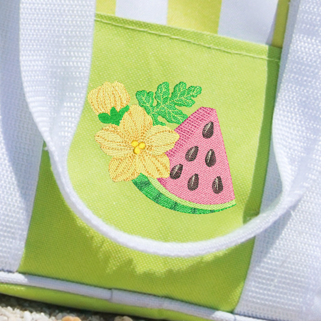 This is an image of a machine embroidery design from Stitches & Strokes, featuring a watermelon with a watermelon bloom. This watermelon machine embroidery design is perfect for embroidery on kitchen towels, beach towels, and tote bags.