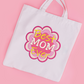 This is an image of a machine embroidery design featuring a "Best Mom Ever" quote in a flower shaped background. This machine embroidery design is perfect for embroidery on Mother's Day Gifts like tote bags.