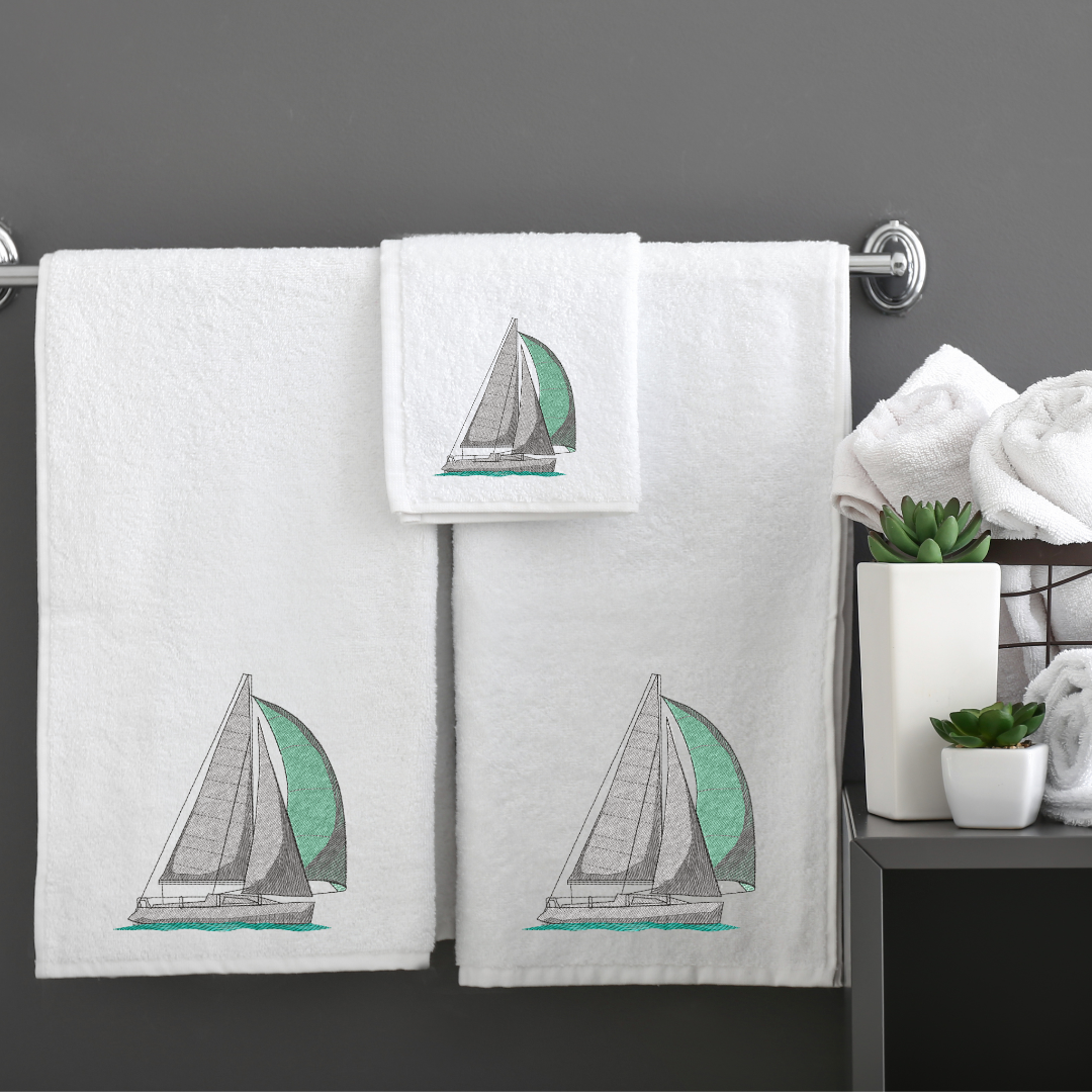 This is an image of a machine embroidery design featuring a blue and grey sailboat. This sailboat machine embroidery design is perfect for embroidery on towels, cushions, and other home décor.