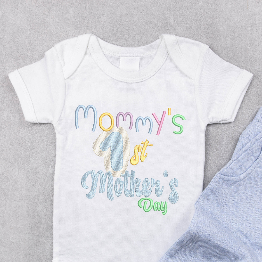 This is an image of a machine embroidery design featuring a "Mommy's 1st Mother's Day" quote. This machine embroidery design for new mommy's is perfect for embroidery on newborn baby onesies to wear on Mother's Day.